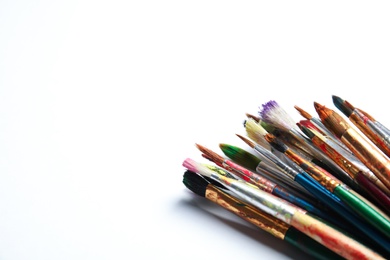 Photo of Different paint brushes on white background. Space for text