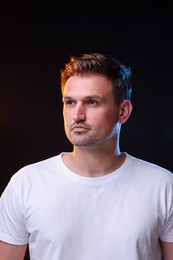 Portrait of handsome man on black background