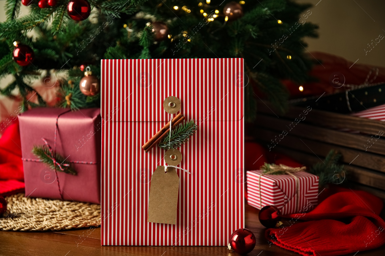 Photo of Beautifully decorated Christmas present and decor on wooden table