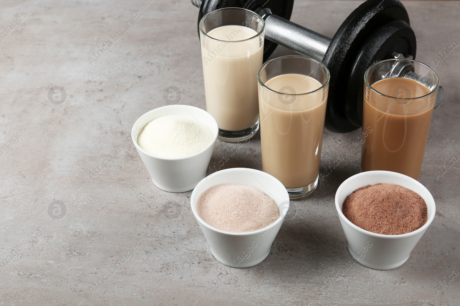 Photo of Composition with protein shakes in glasses on table. Space for text