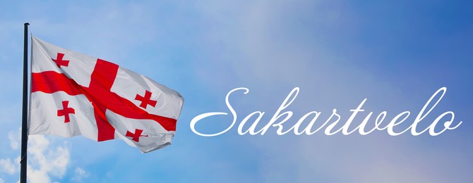 Image of Word Sakartvelo meaning native name of Georgia near its national flag against sky, banner design