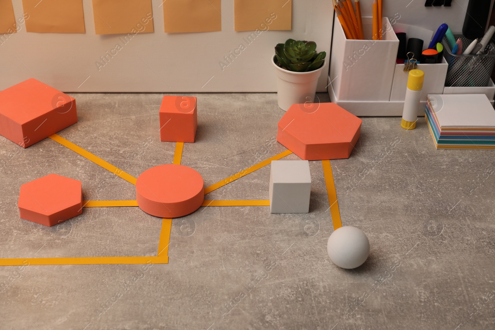 Photo of Business process scheme with geometric figures and stationery on light grey table