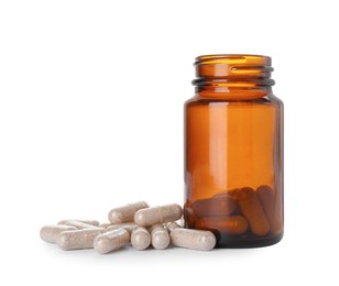 Photo of Gelatin capsules and bottle on white background