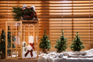 Beautiful Christmas lantern on windowsill in decorated room