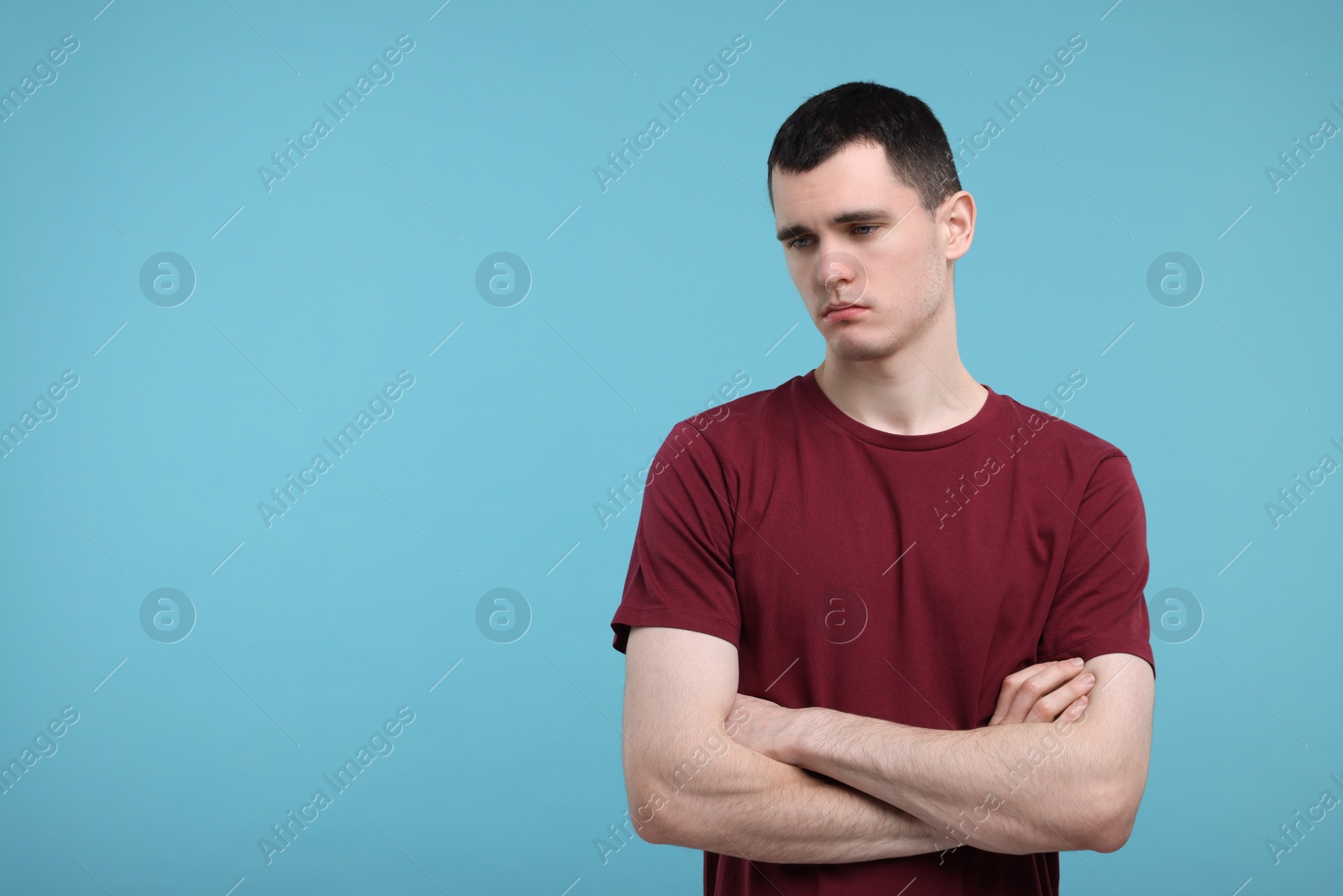 Photo of Portrait of sad man on light blue background, space for text