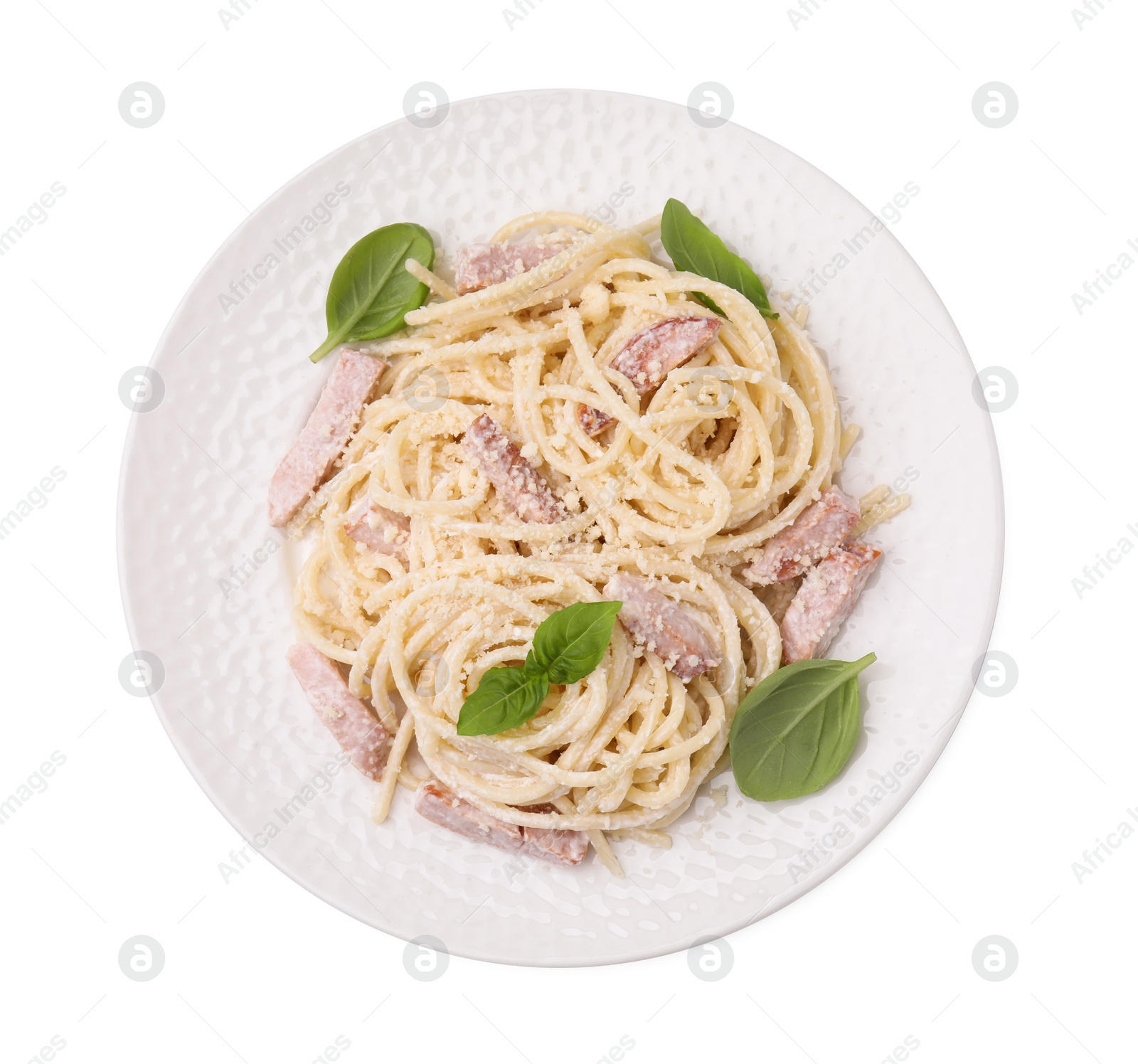 Photo of Plate of tasty pasta Carbonara with basil leaves isolated on white, top view