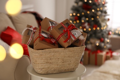 Photo of Basket full of gift boxes for Christmas advent calendar in room