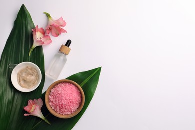 Photo of Flat lay composition with different spa products and beautiful flowers on white table. Space for text