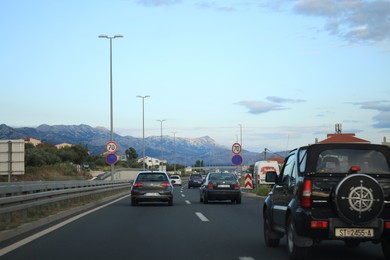 Trogir, Croatia - September 24, 2023: Picturesque view of highway with cars and mountains