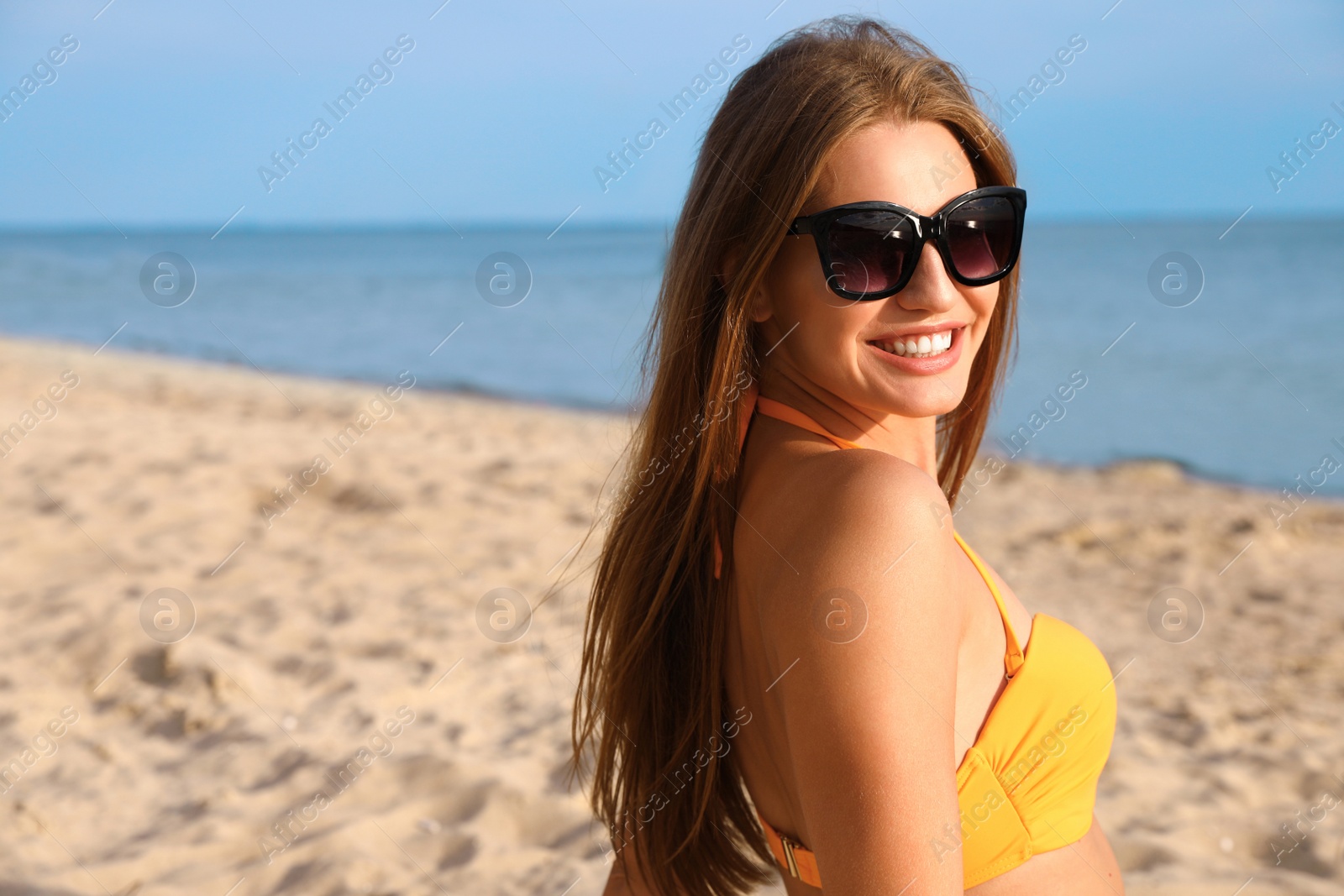 Photo of Beautiful young woman in bikini on beach