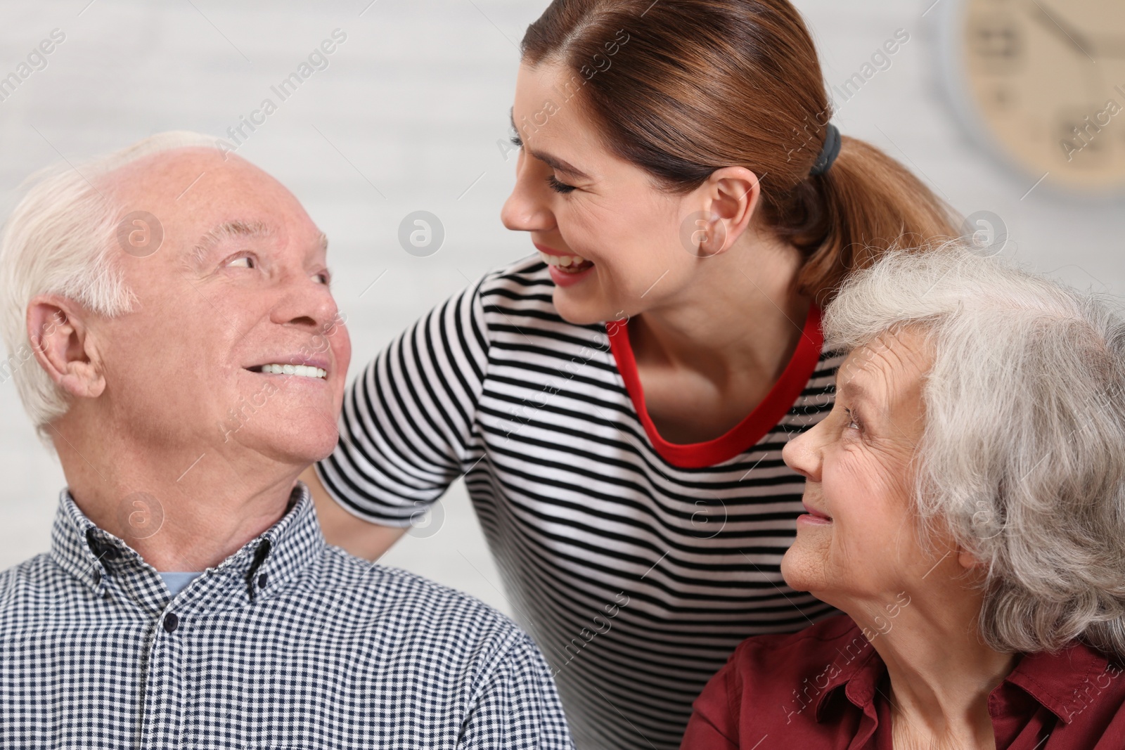 Photo of Elderly couple with female caregiver at home