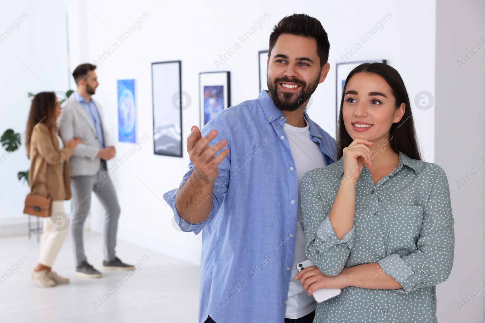 Photo of Happy couple at exhibition in art gallery