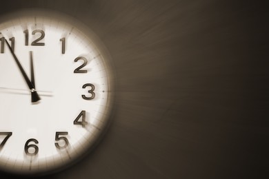 Image of Fleeting time concept. Clock on dark background, space for text. Motion effect
