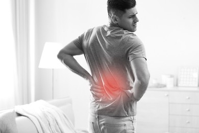 Image of Man suffering from back pain at home. Bad posture problem