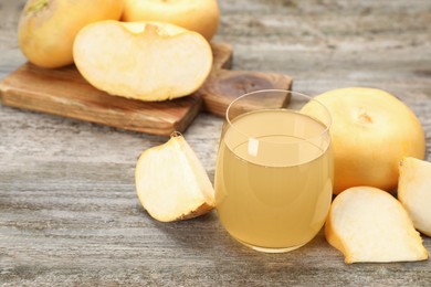 Photo of Glass of freshly made turnip juice on wooden table