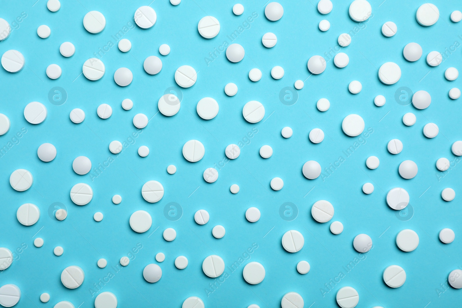 Photo of White pills on color background, flat lay