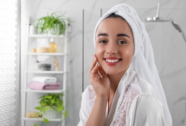 Photo of Beautiful young woman with perfect skin in bathroom, space for text. Facial wash