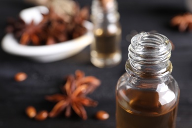 Anise essential oil in bottle on table, closeup. Space for text