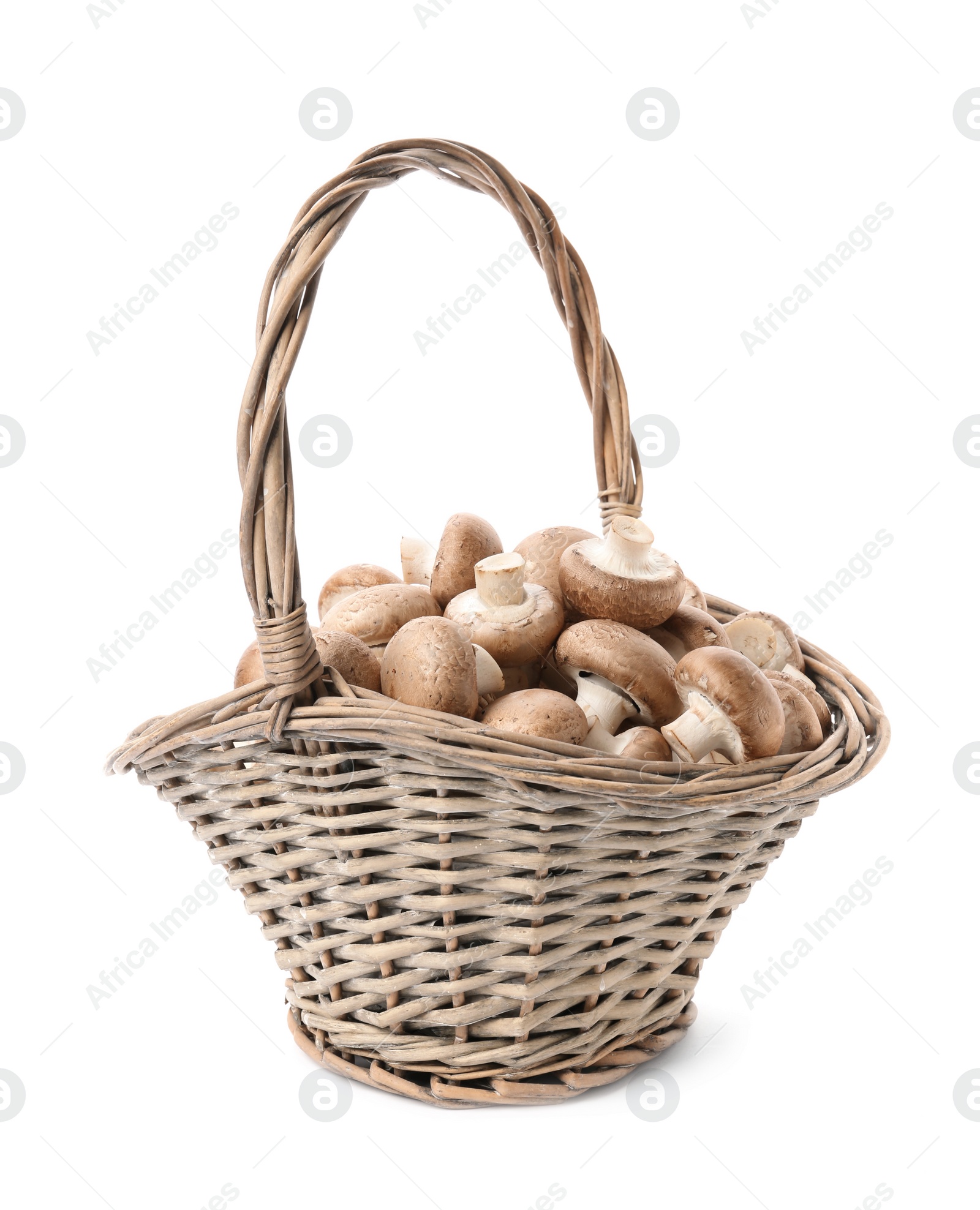 Photo of Wicker basket with fresh raw champignon mushrooms on white background