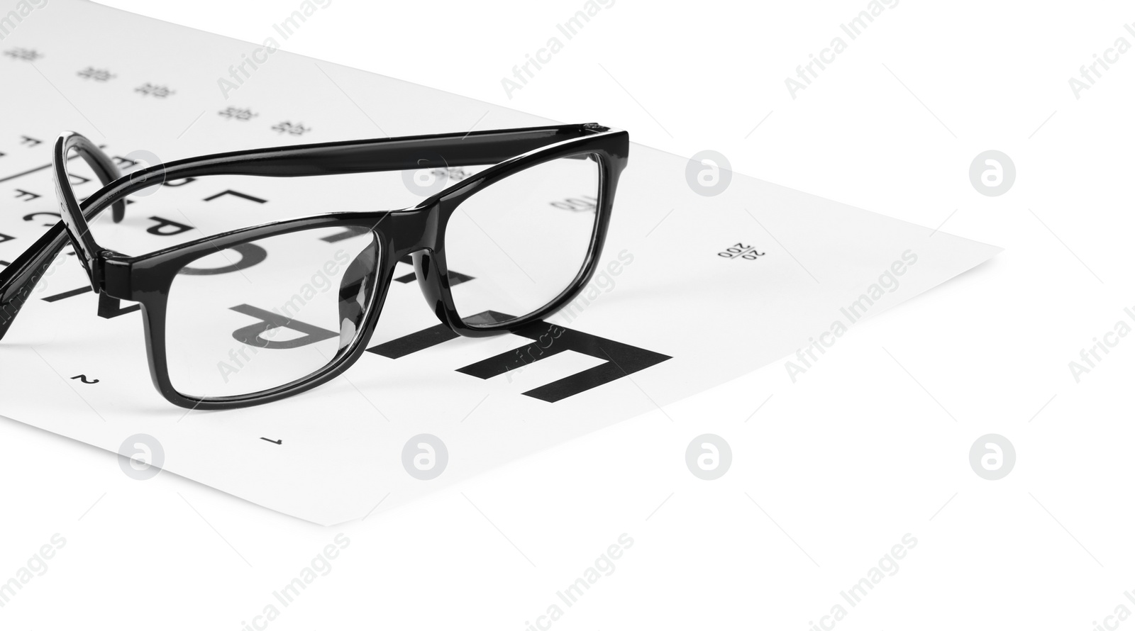 Photo of Glasses and vision test chart isolated on white