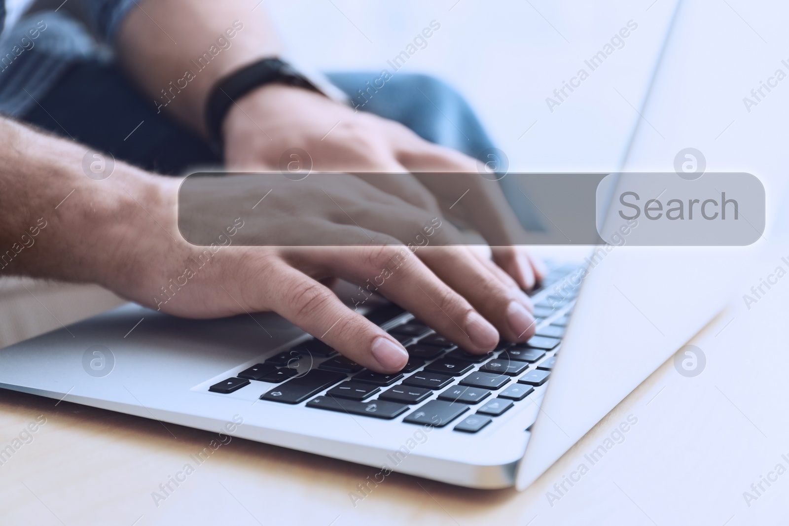 Image of Search bar of website over laptop. Man using computer at table, closeup