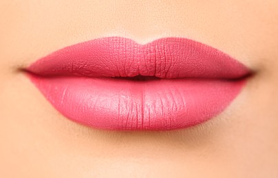 Woman with beautiful perfect lips after permanent makeup procedure, closeup