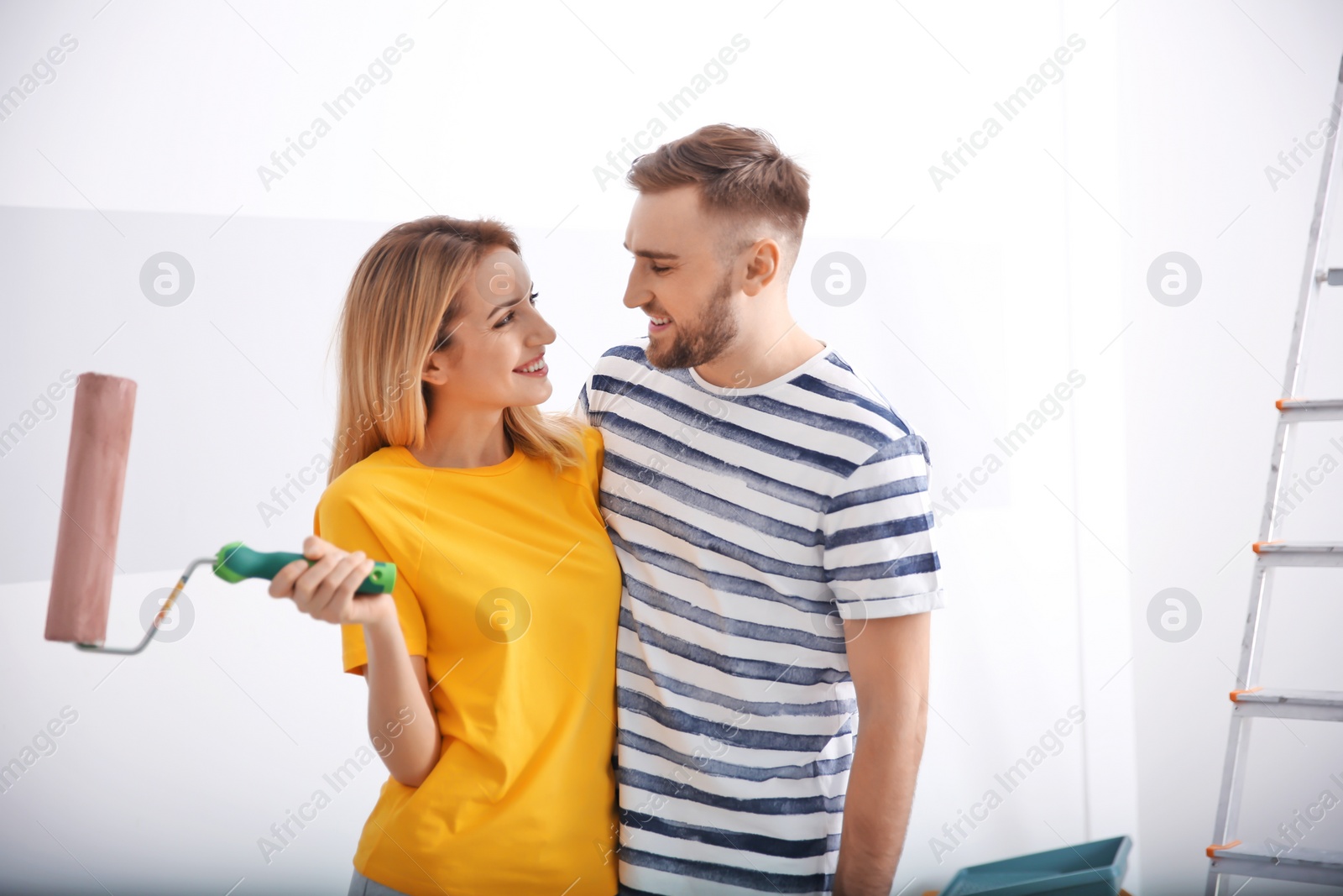 Photo of Young couple during apartment renovation, indoors