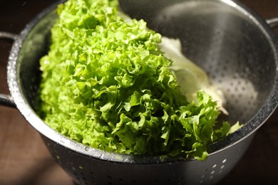 Fresh lettuce on brown table, closeup. Salad greens