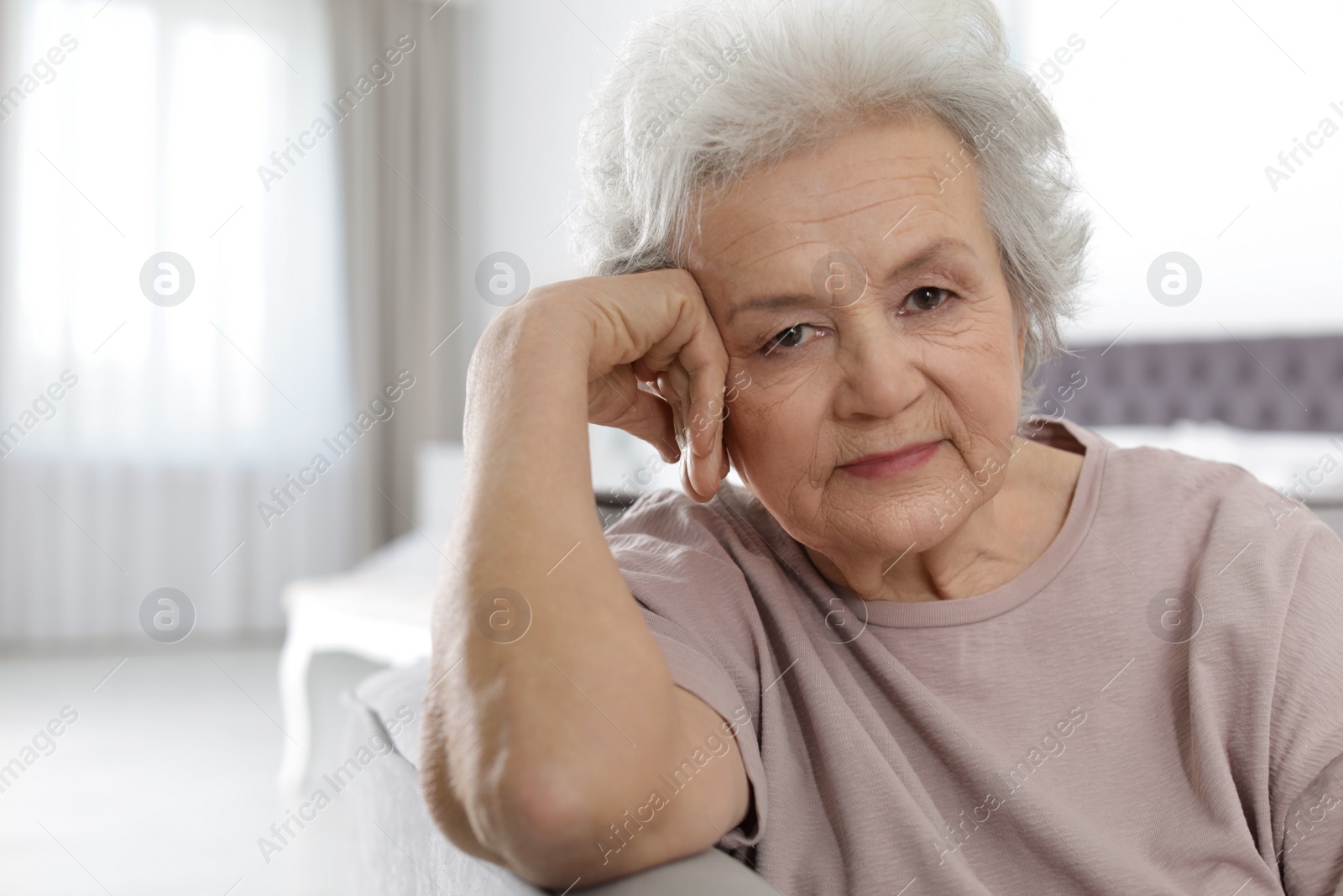 Photo of Portrait of mature woman in living room