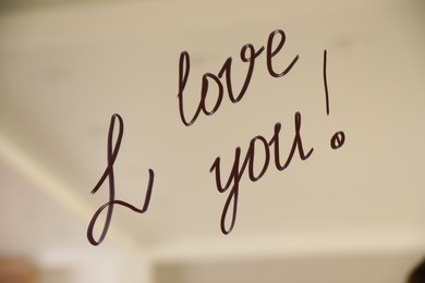 Handwritten text I Love You on mirror in room. Romantic message