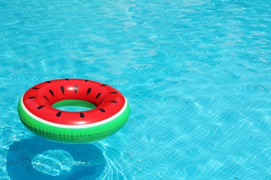 Photo of Inflatable ring floating in pool on sunny day