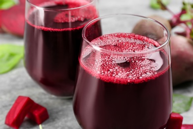 Photo of Freshly made beet juice on table, closeup view