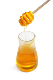 Photo of Honey in glass jar and dipper on white background