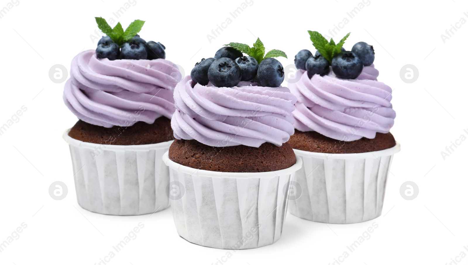 Photo of Sweet cupcakes with fresh blueberries on white background