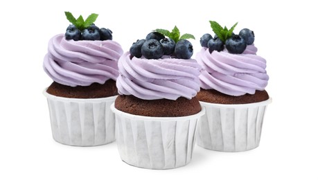 Photo of Sweet cupcakes with fresh blueberries on white background