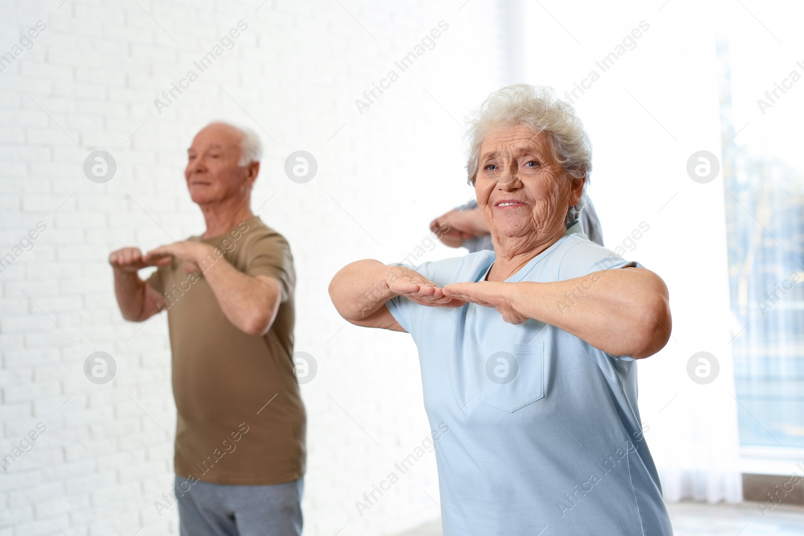 Photo of Elderly people training in hospital gym. Senior patients care