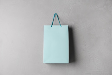 Photo of Paper shopping bag hanging on grey wall