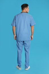 Doctor in clean uniform on blue background