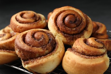 Photo of Tasty cinnamon rolls on table, closeup view