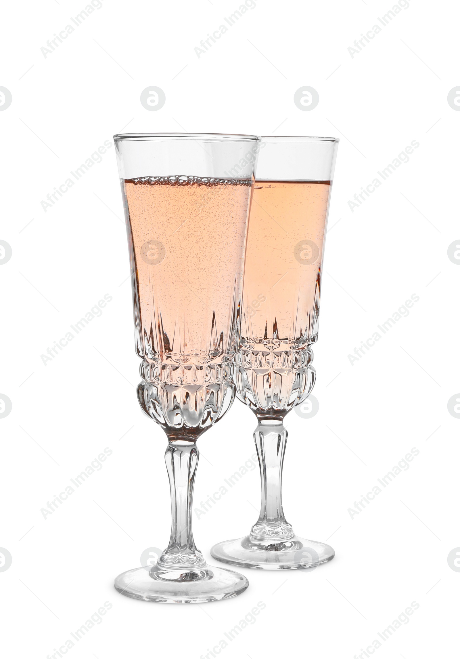 Photo of Glasses of sparkling rose champagne isolated on white
