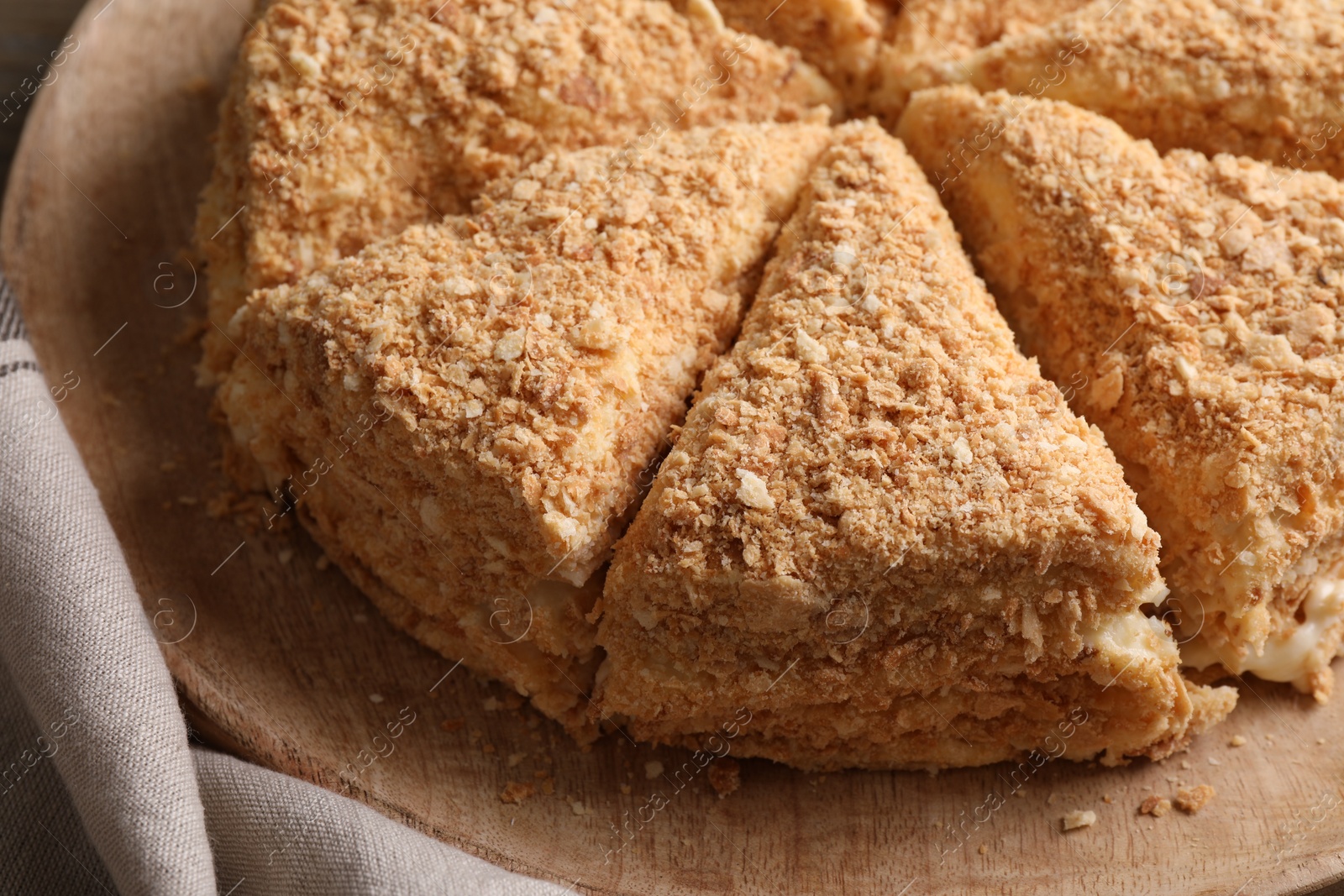 Photo of Delicious cut Napoleon cake on table, closeup