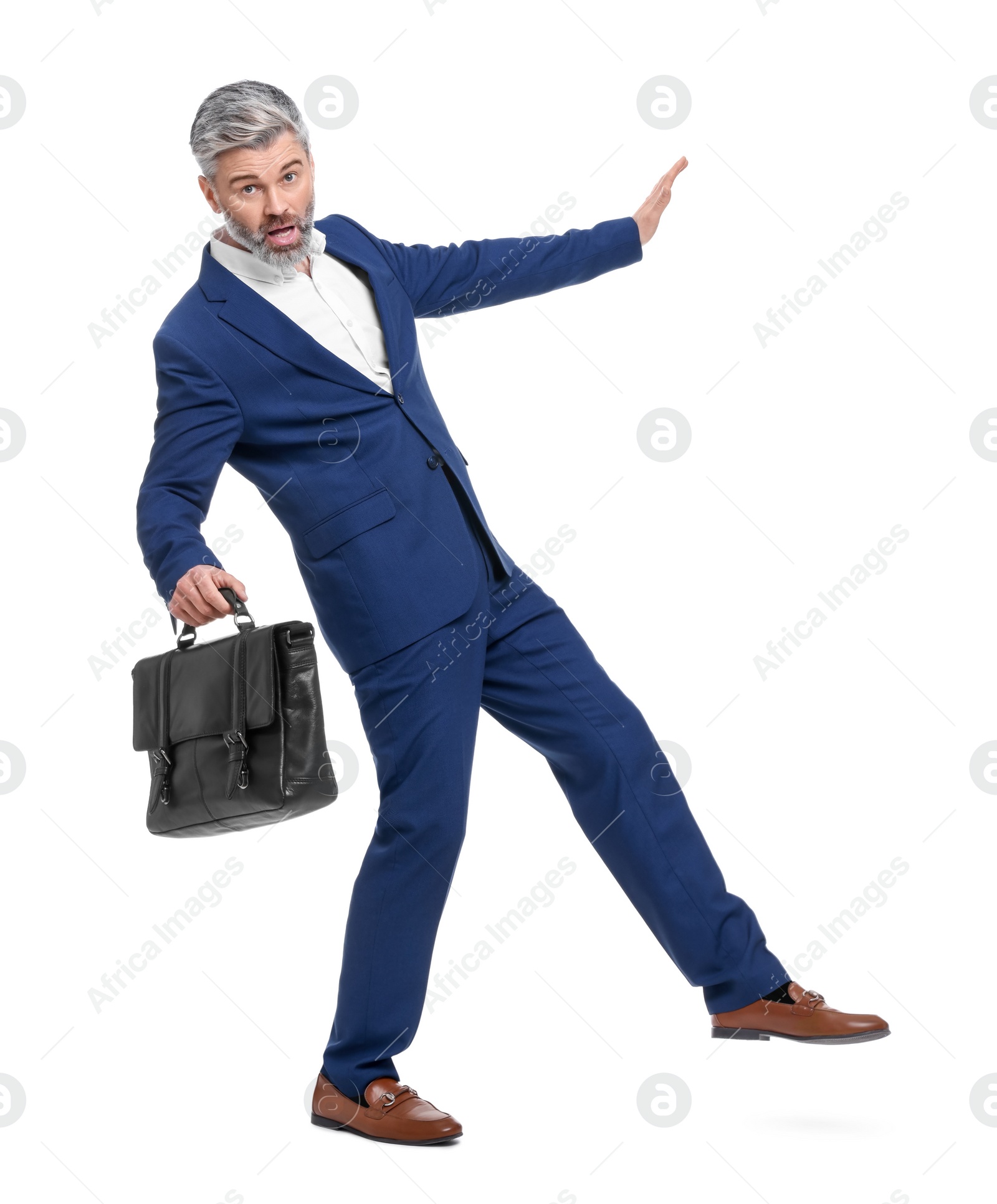 Photo of Mature businessman with briefcase posing on white background