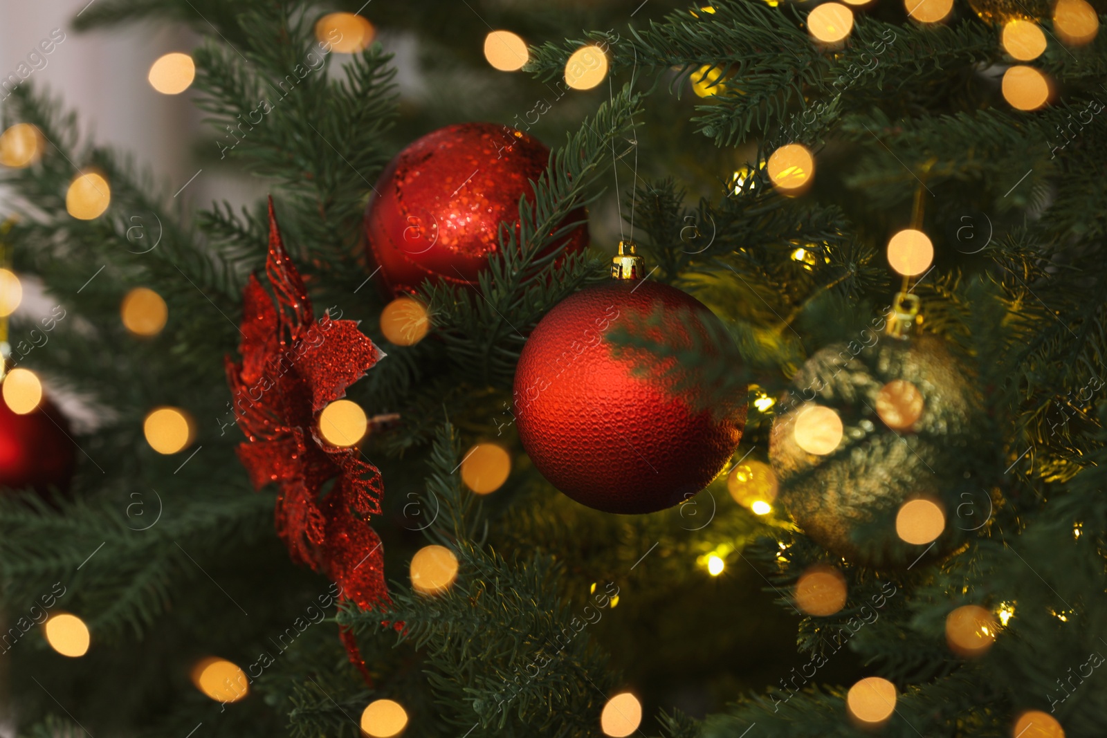 Photo of Christmas tree decorated with festive balls, closeup