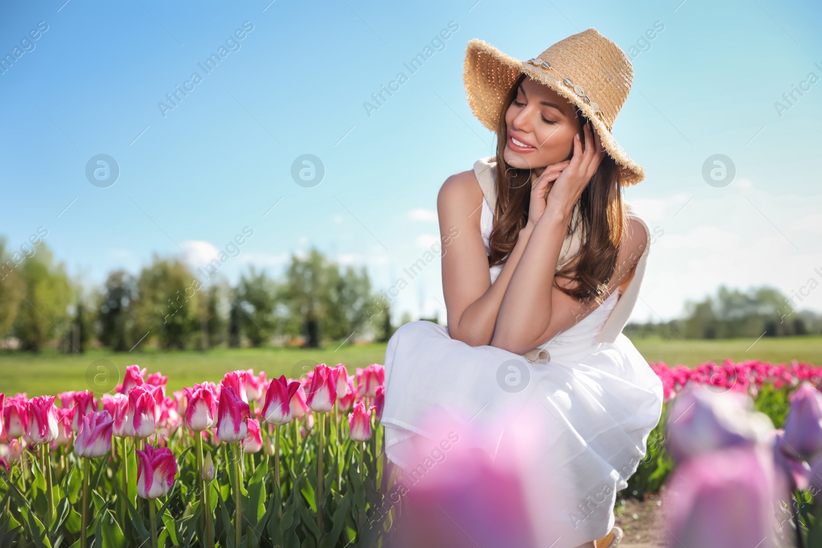 Photo of Woman in beautiful tulip field on sunny day