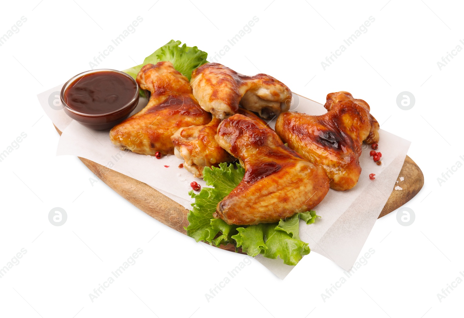 Photo of Board with marinade, chicken wings, spices and lettuce isolated on white