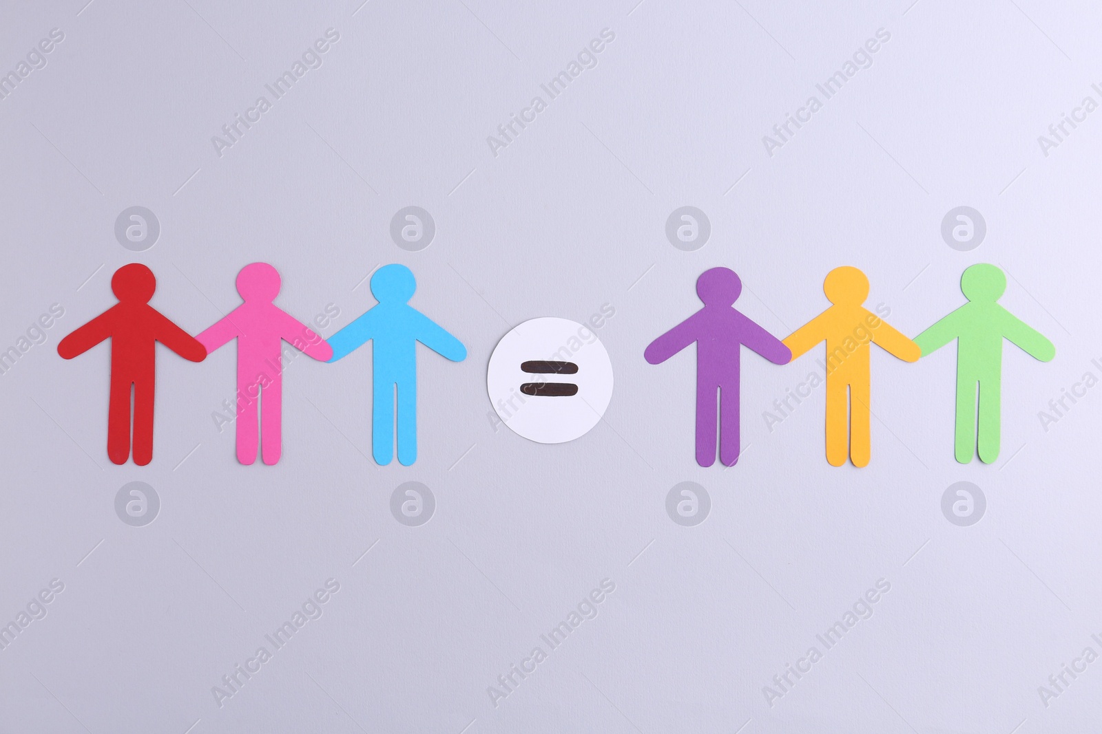 Photo of Paper human figures and equals sign on light background, flat lay