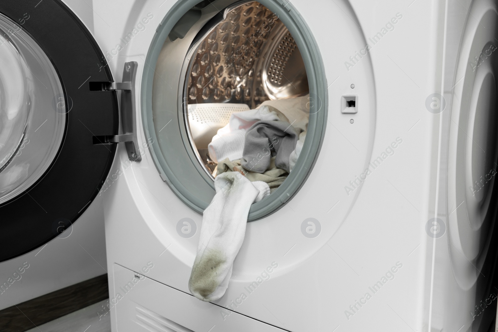 Photo of Many dirty socks in washing machine, closeup