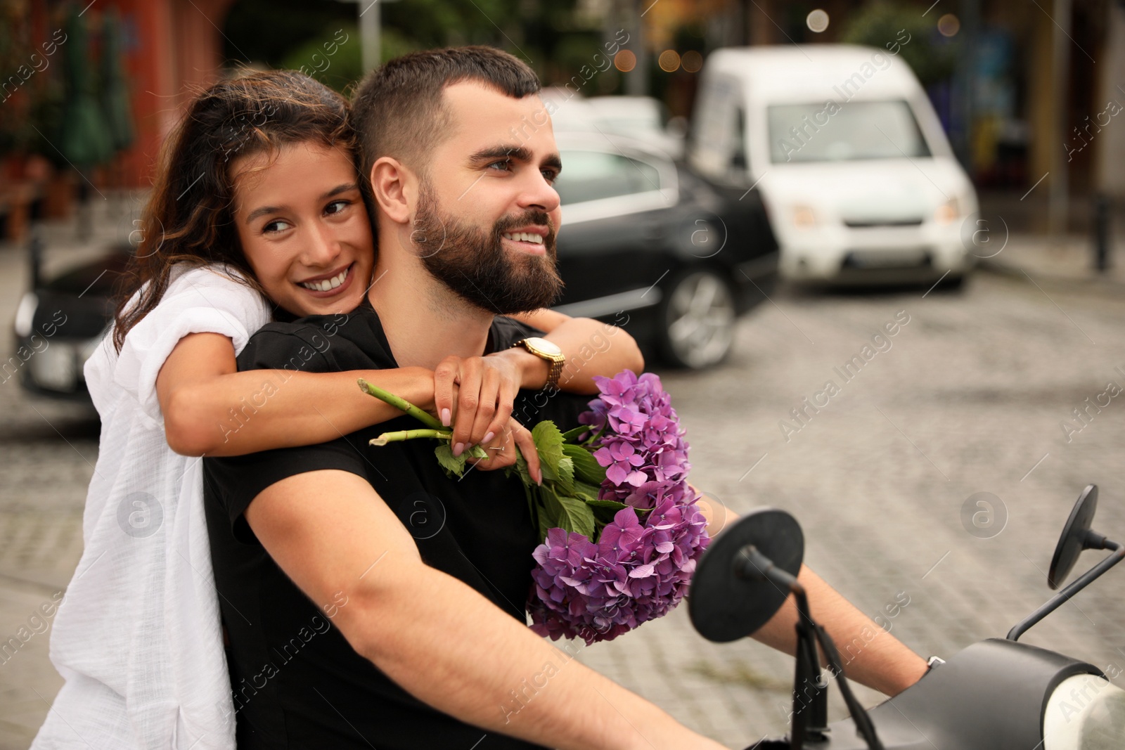 Photo of Beautiful young couple riding motorcycle on city street