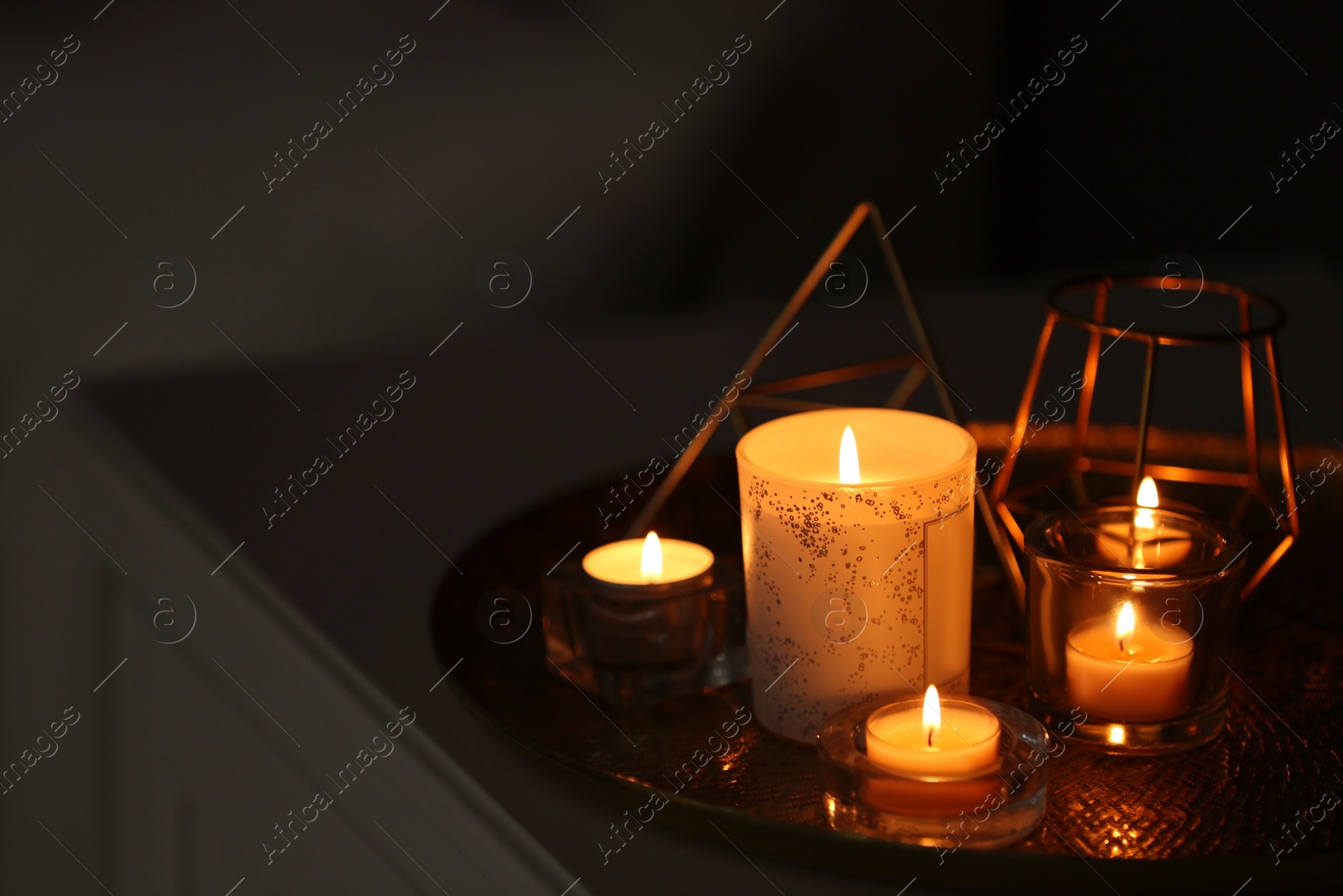 Photo of Beautiful burning candles and decor on table at home. Space for text