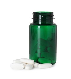 Photo of Bottle and pile of vitamin pills isolated on white